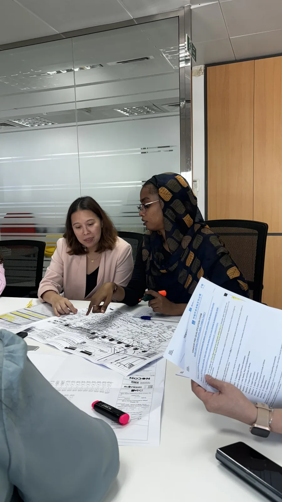 ALSUWEIDI colleagues working through a brief together
