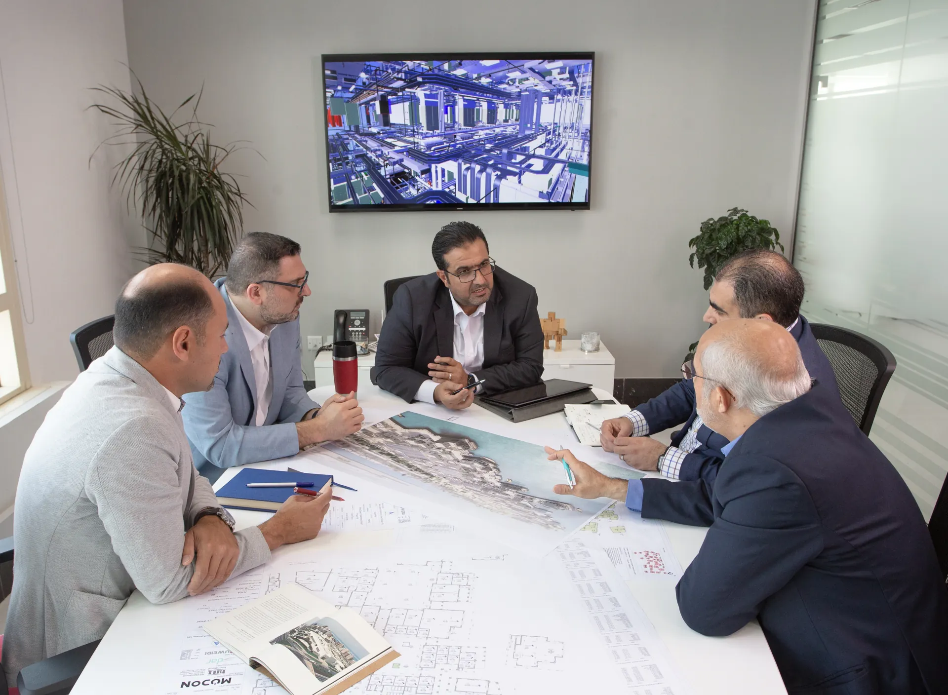 Specialists from different disciplines reviewing drawings together