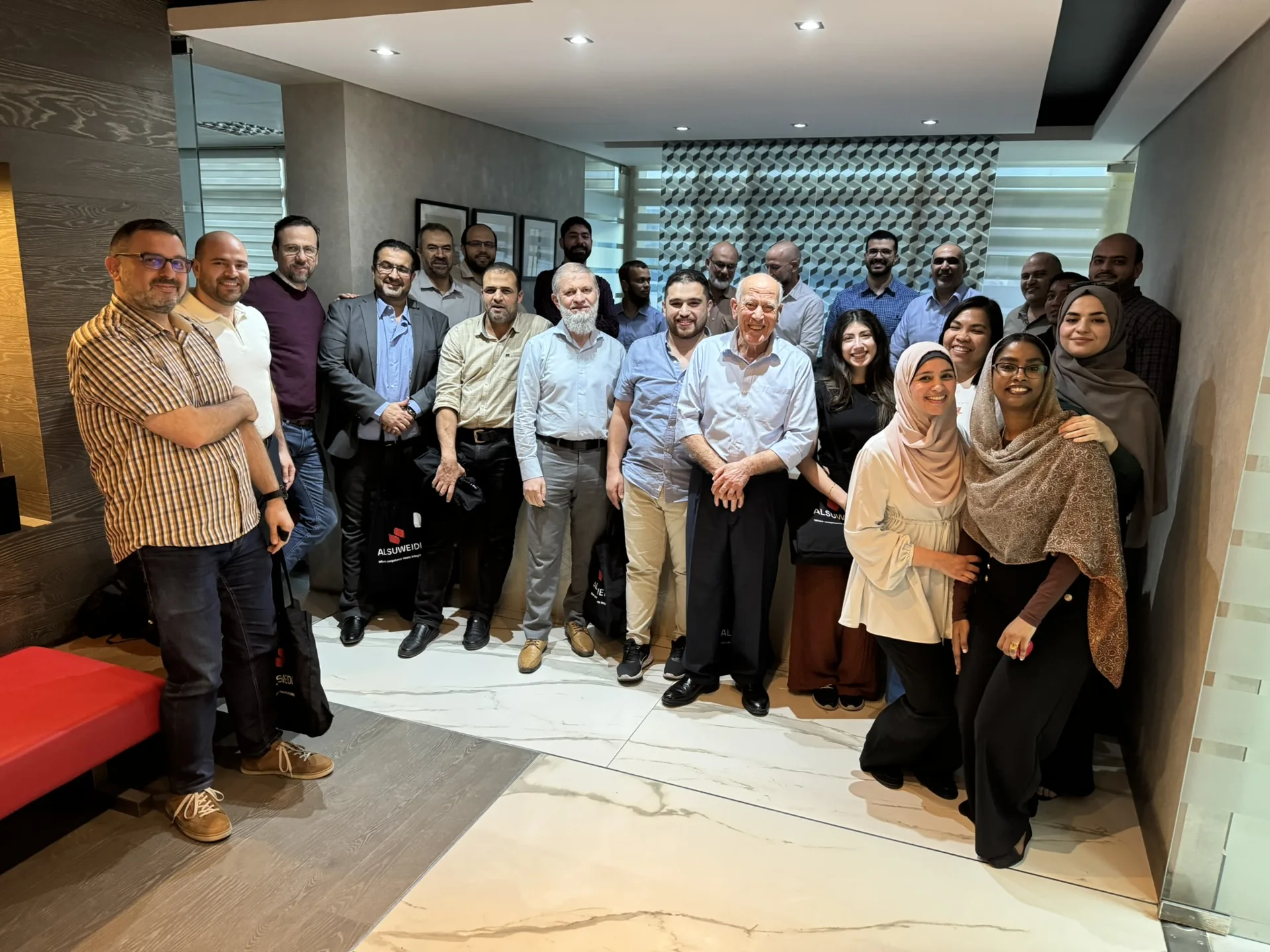 ALSUWEIDI colleagues together in the office